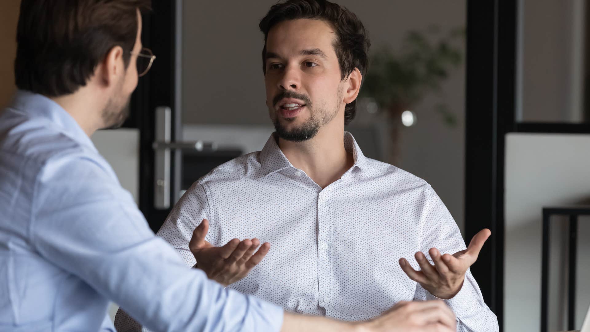 Man asking "Why'd you call in yesterday?" to his co-worker.