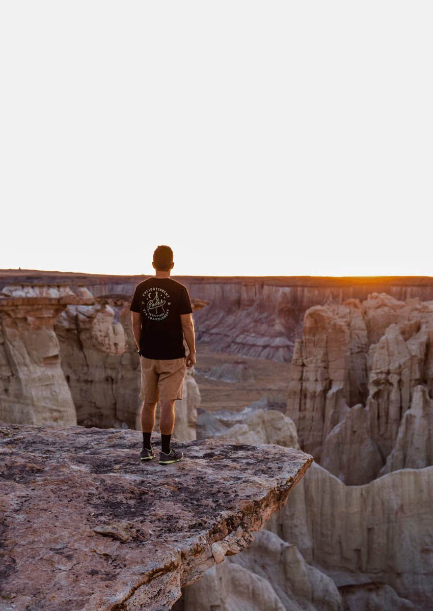 courageous person standing on the edge of a cliff