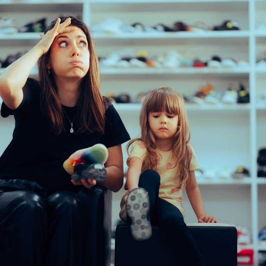 stressed mom sitting next to young daughter