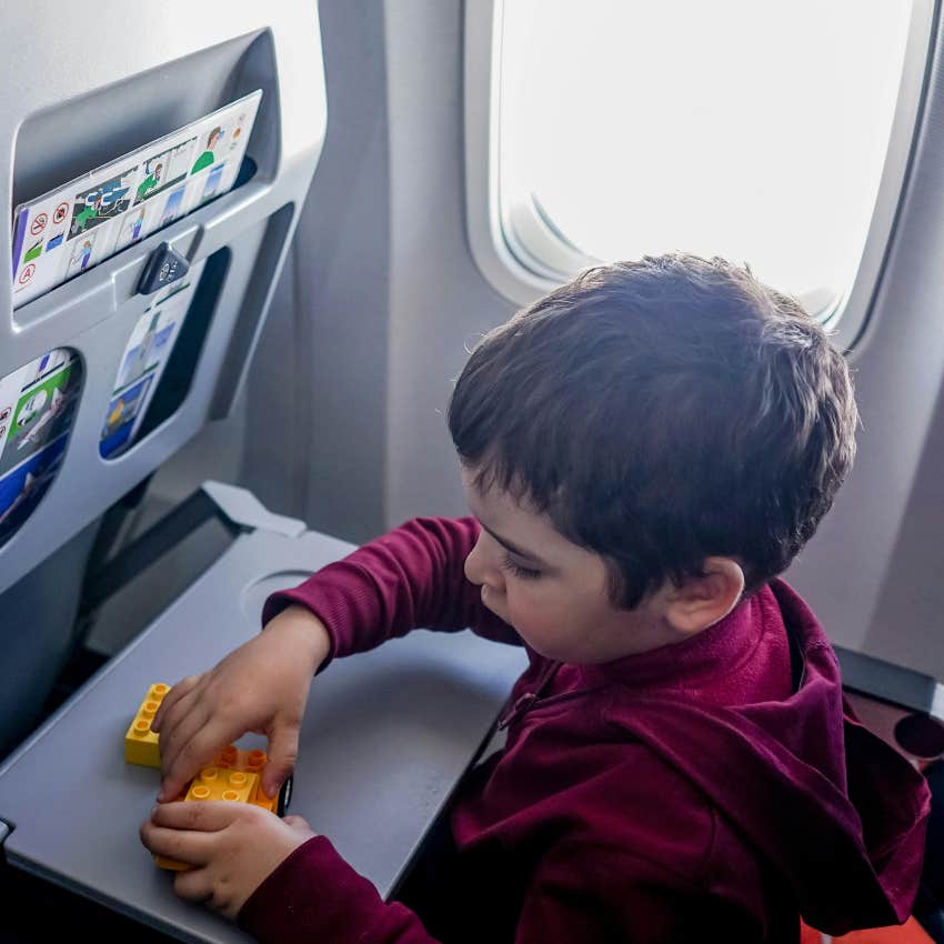 kid sitting by himself in economy