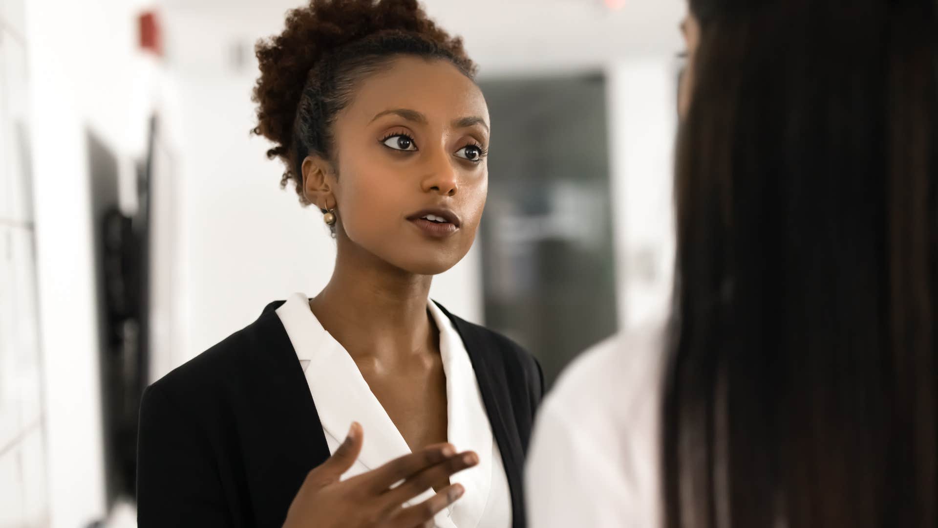 strong professional woman who can handle conflict and discomfort talking to colleague