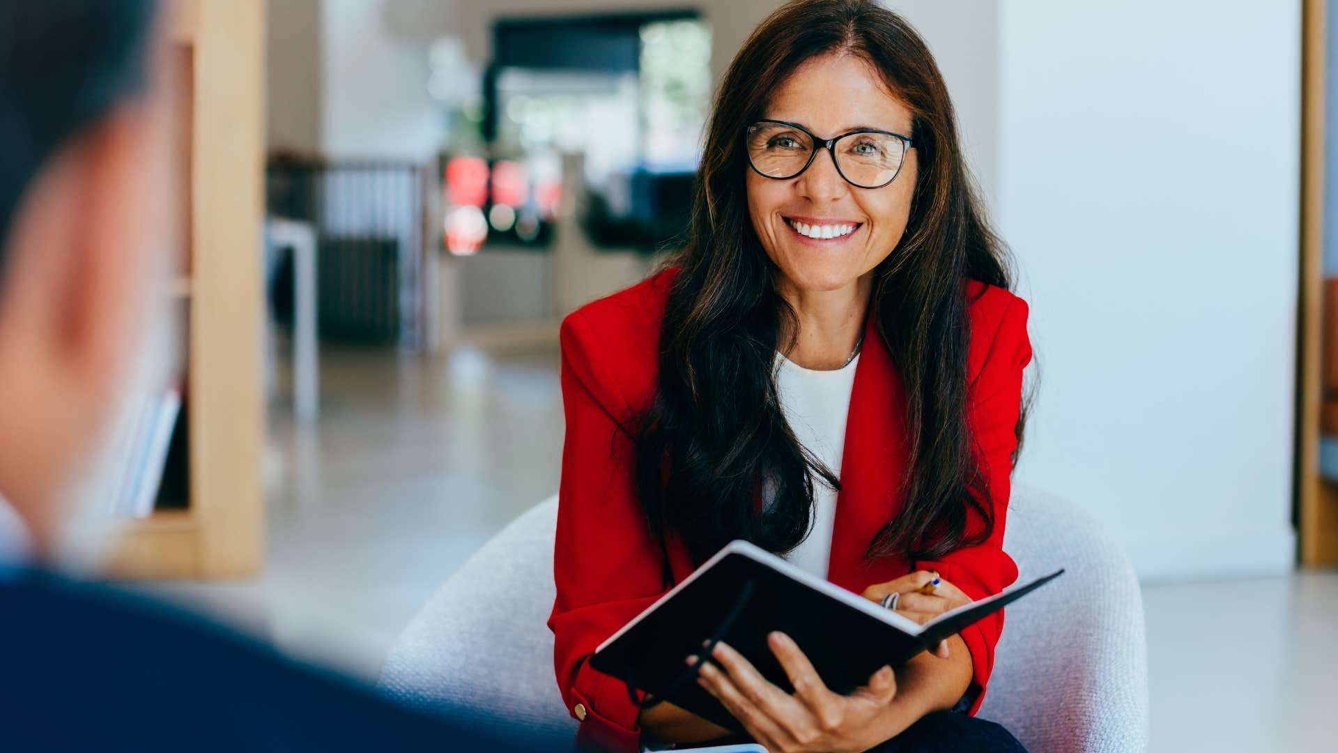 intelligent woman who's intentional with her effort talking to colleague at work