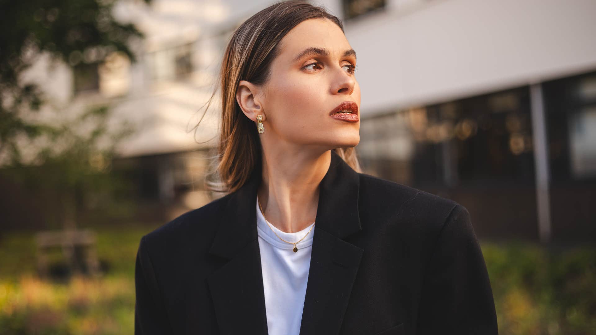 realistic woman sitting outside thinking
