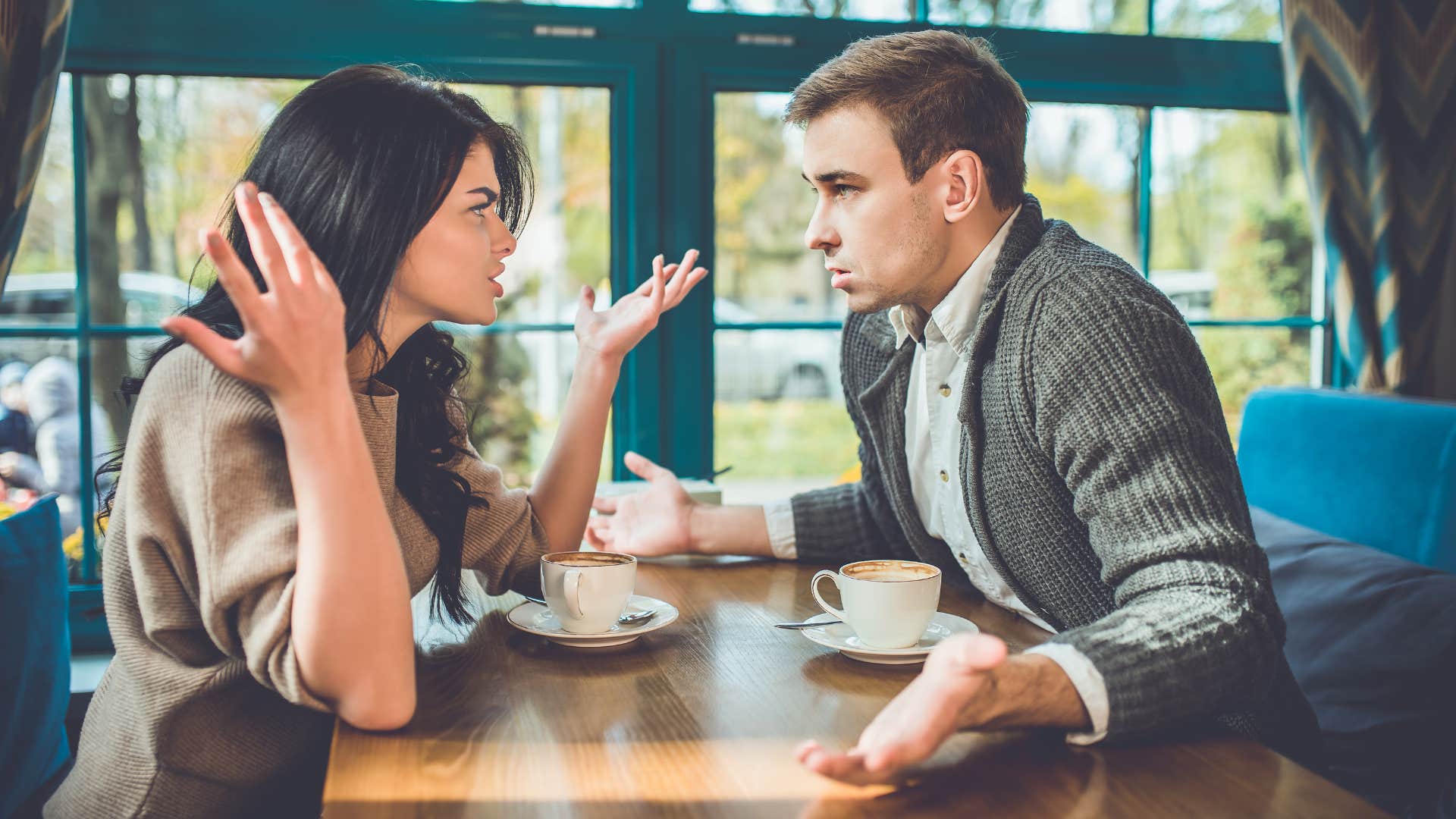 couple arguing with woman telling man everyone else agrees with me
