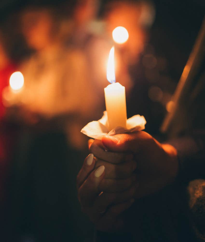 women with candles showing blessing ritual