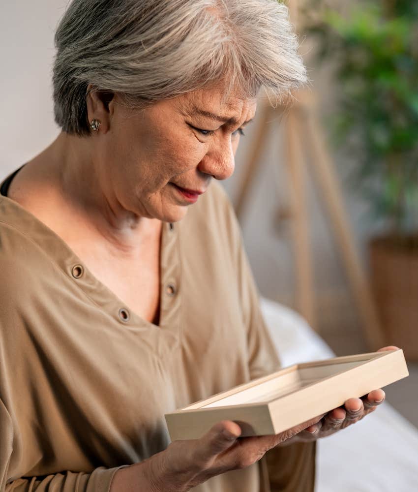 sad person looks at photo in frame showing memory of narcissist