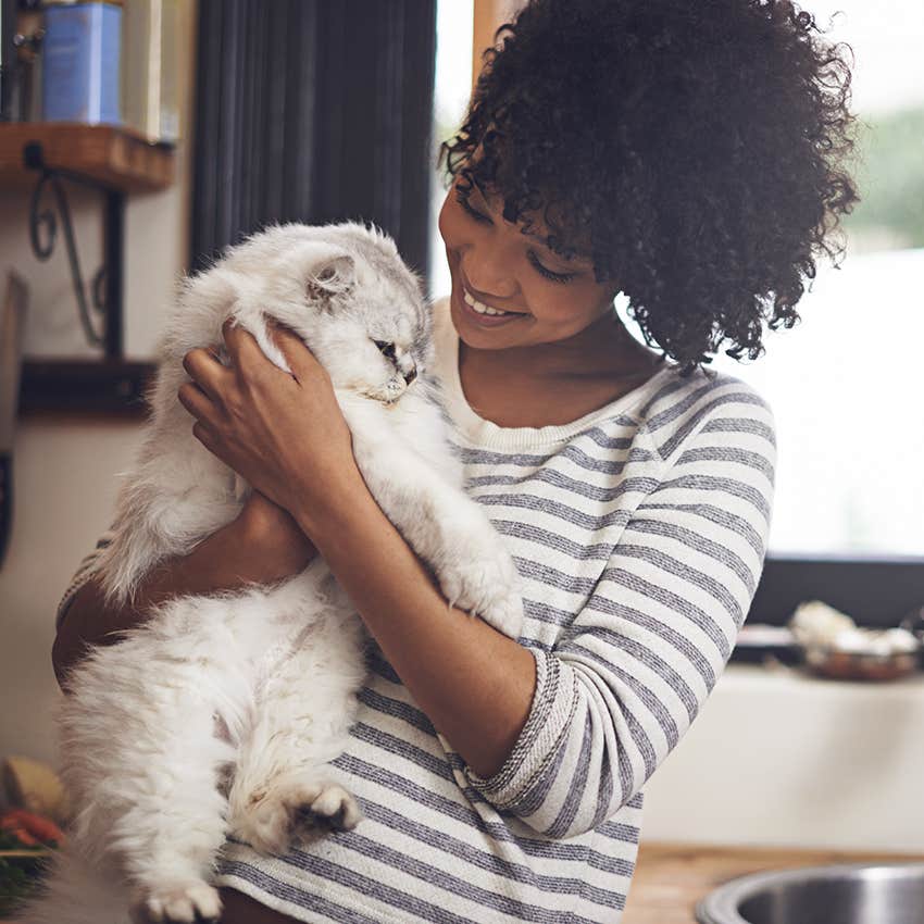 woman holding cat in scent-free kitchen