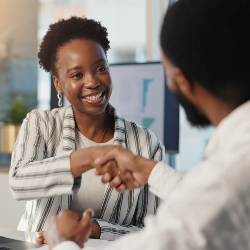 female employee shaking boss's hand