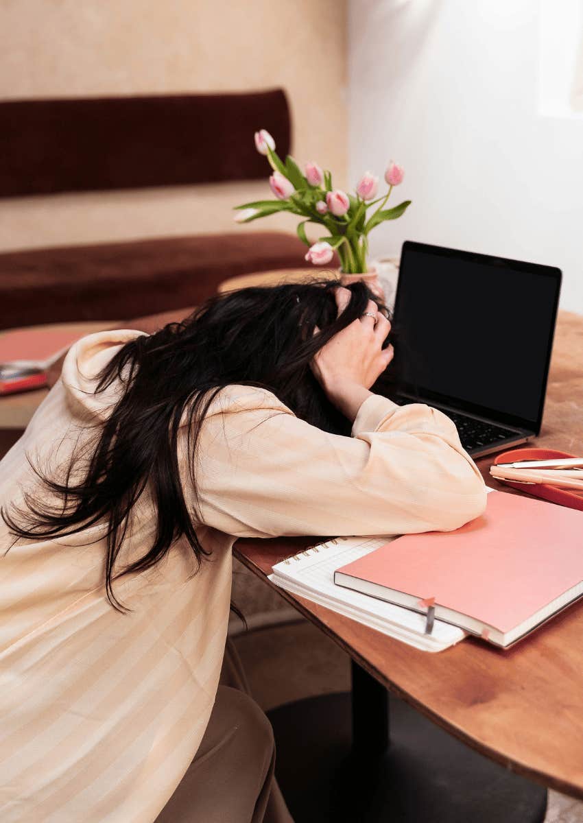 exhausted mom with her head down on desk