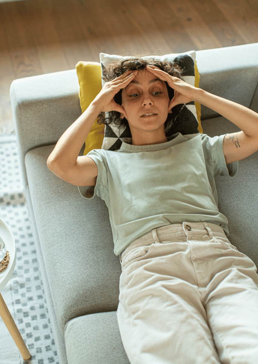 exhausted woman laying on couch