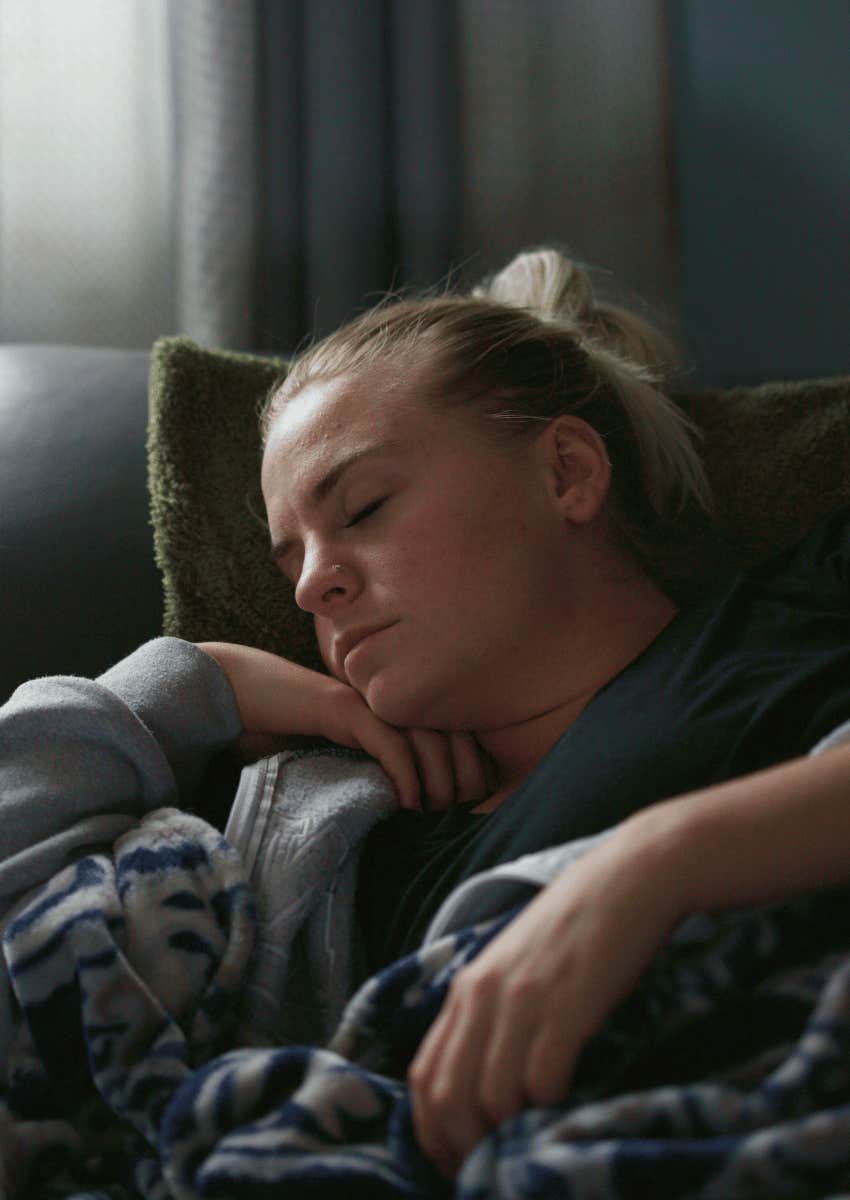 exhausted woman resting on couch