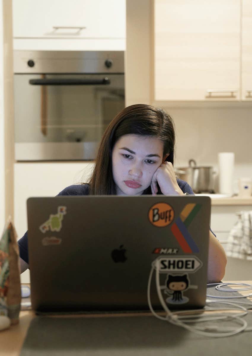 exhausted working mom sitting alone at kitchen table