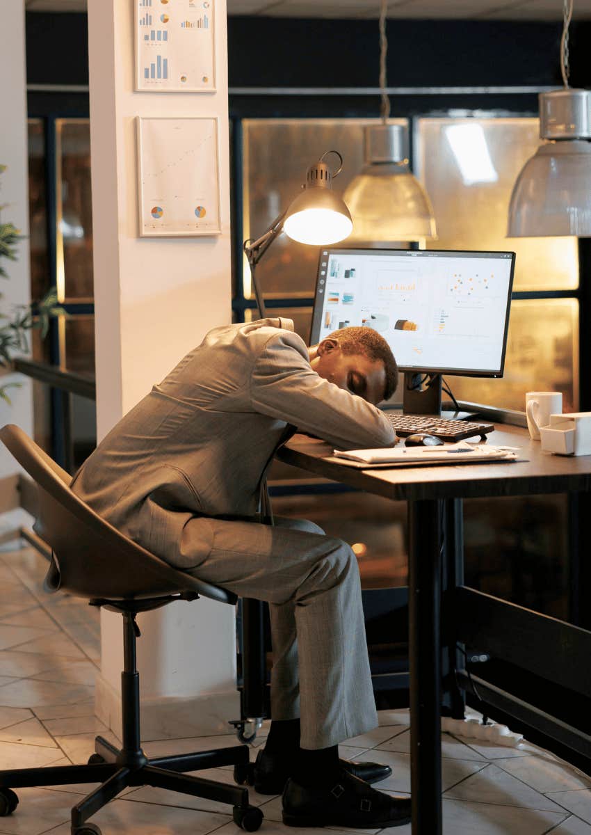 exhausted young adult with his head in his arms