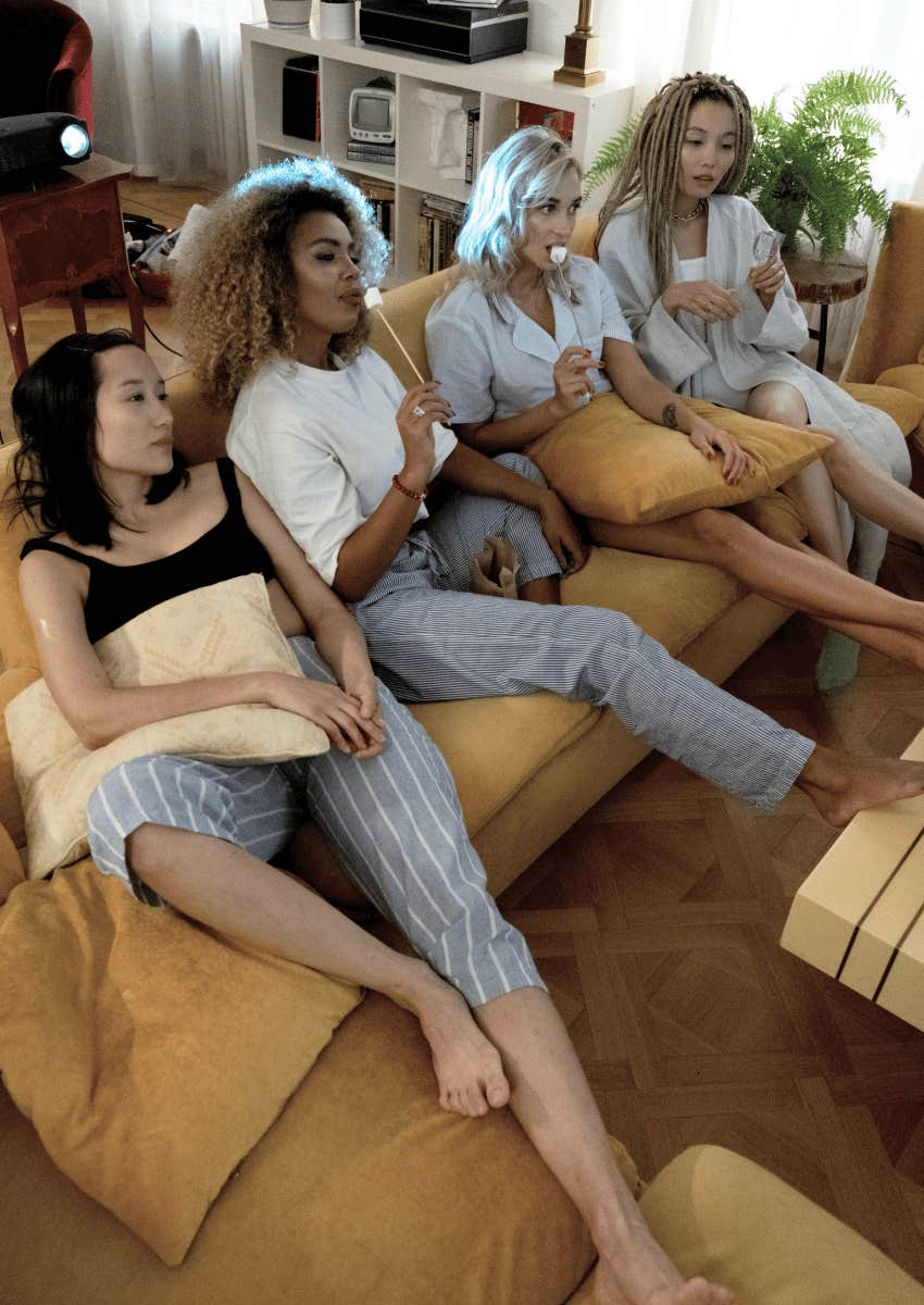 female friends on couch watching movie together