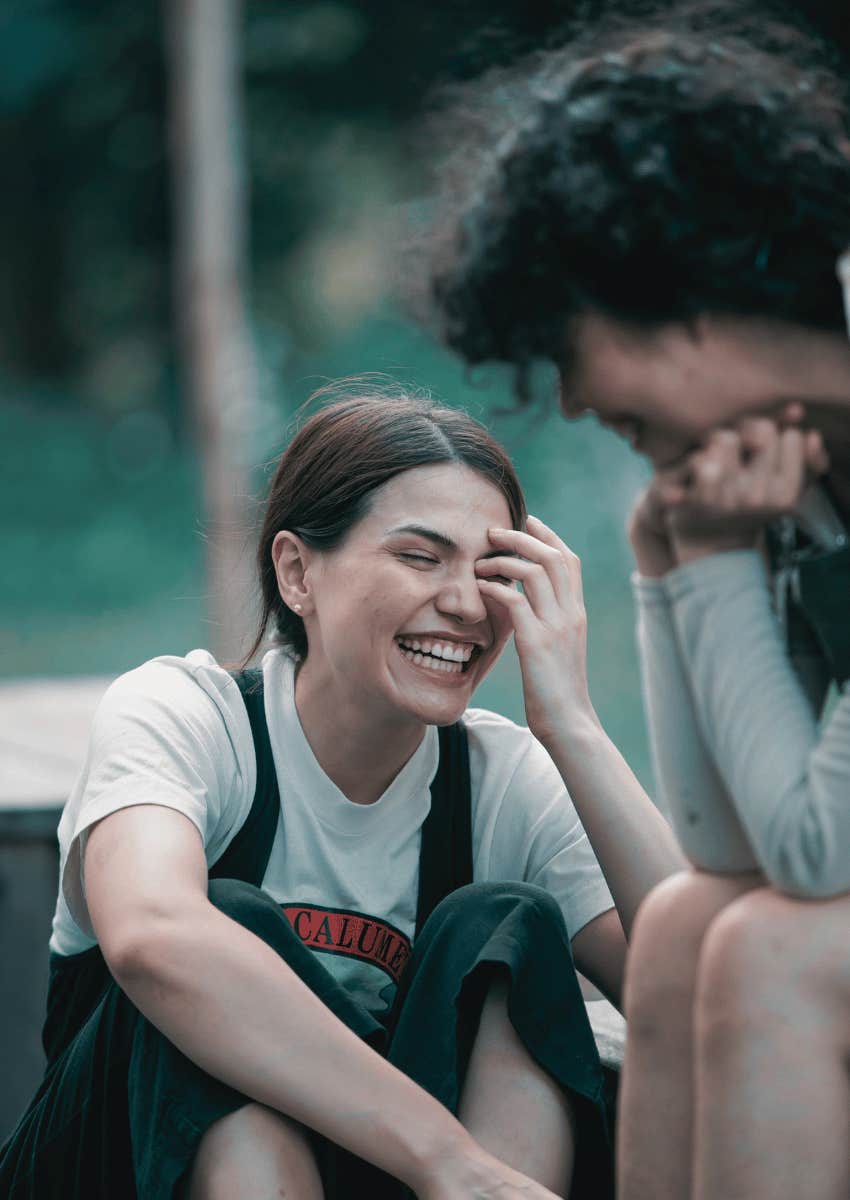 female friends laughing at their dark humor