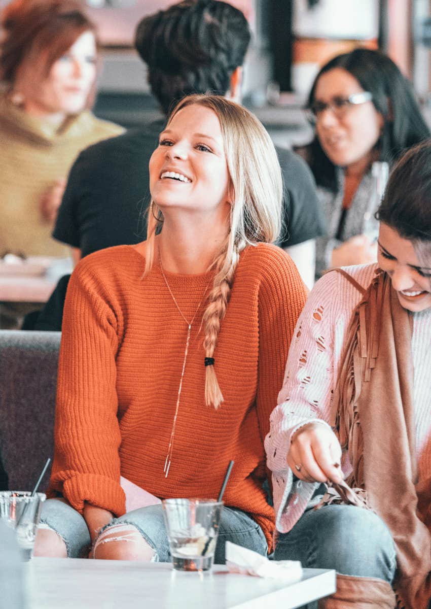 friends sitting close laughing together