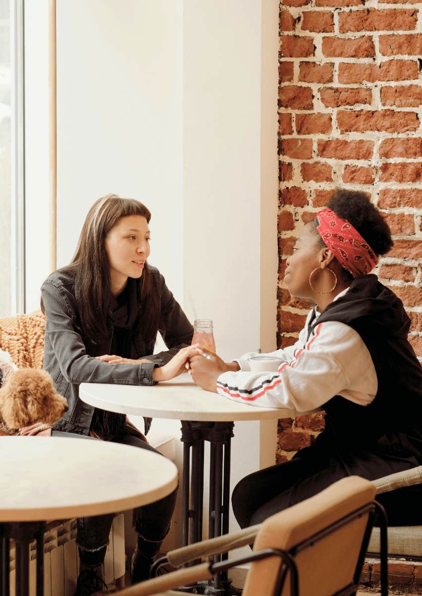 friends talking in café offering support to each other
