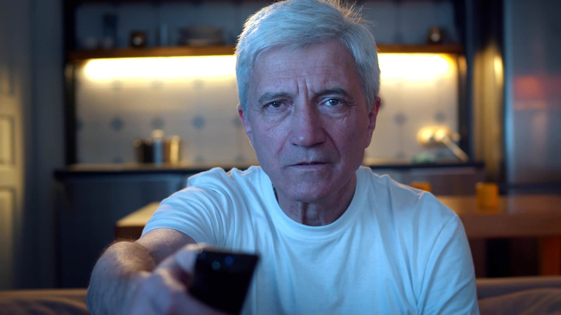 deeply lonely older man saying I'll just leave the TV on clicking through channels