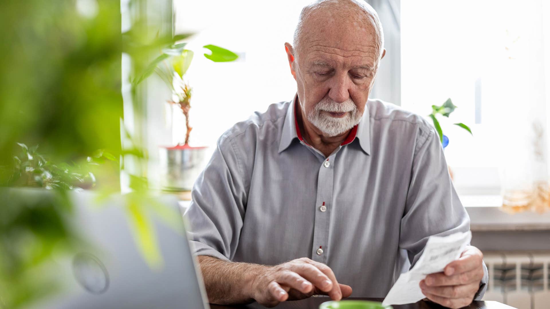 older man doing bills saying I'm just keeping myself occupied