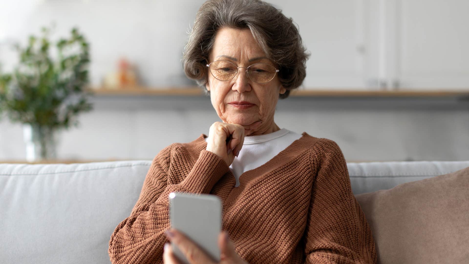 sad older woman on her phone saying you never call