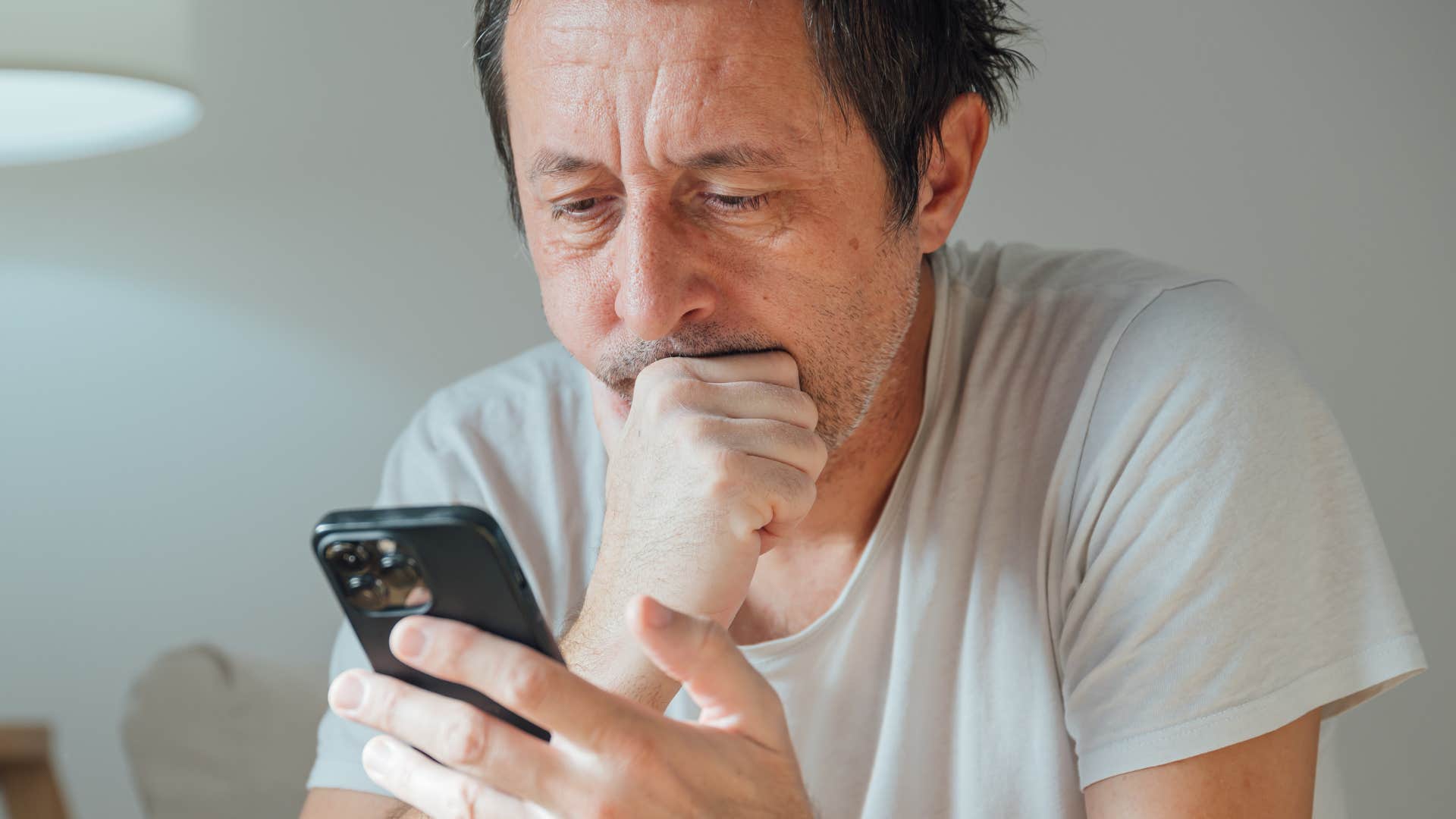 man who's always seeking attention looking at his phone