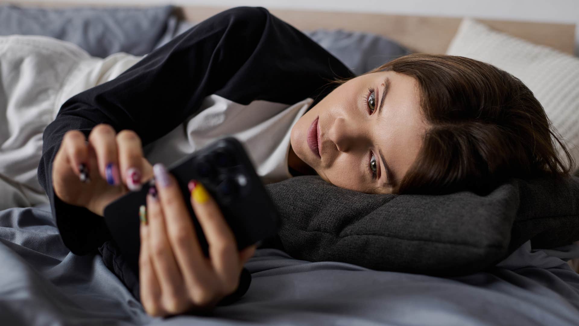 woman scrolling as a distraction from boredom at home