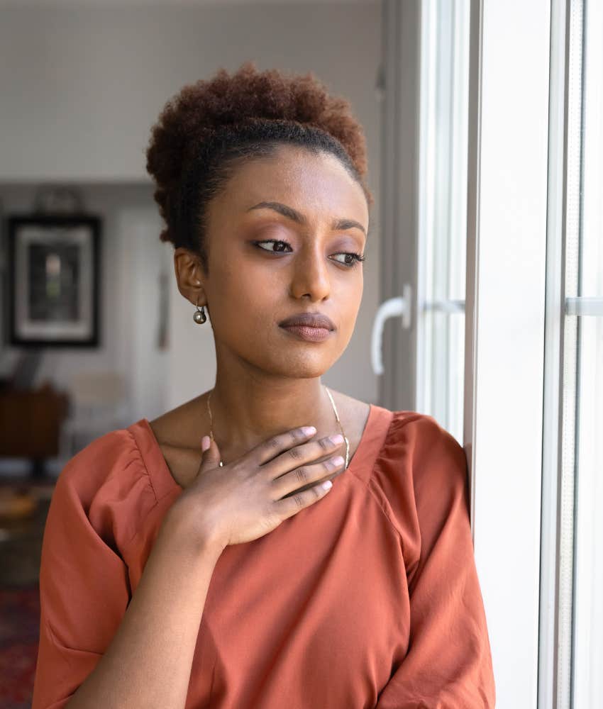 stressed woman with hand to chest showing self trust issues