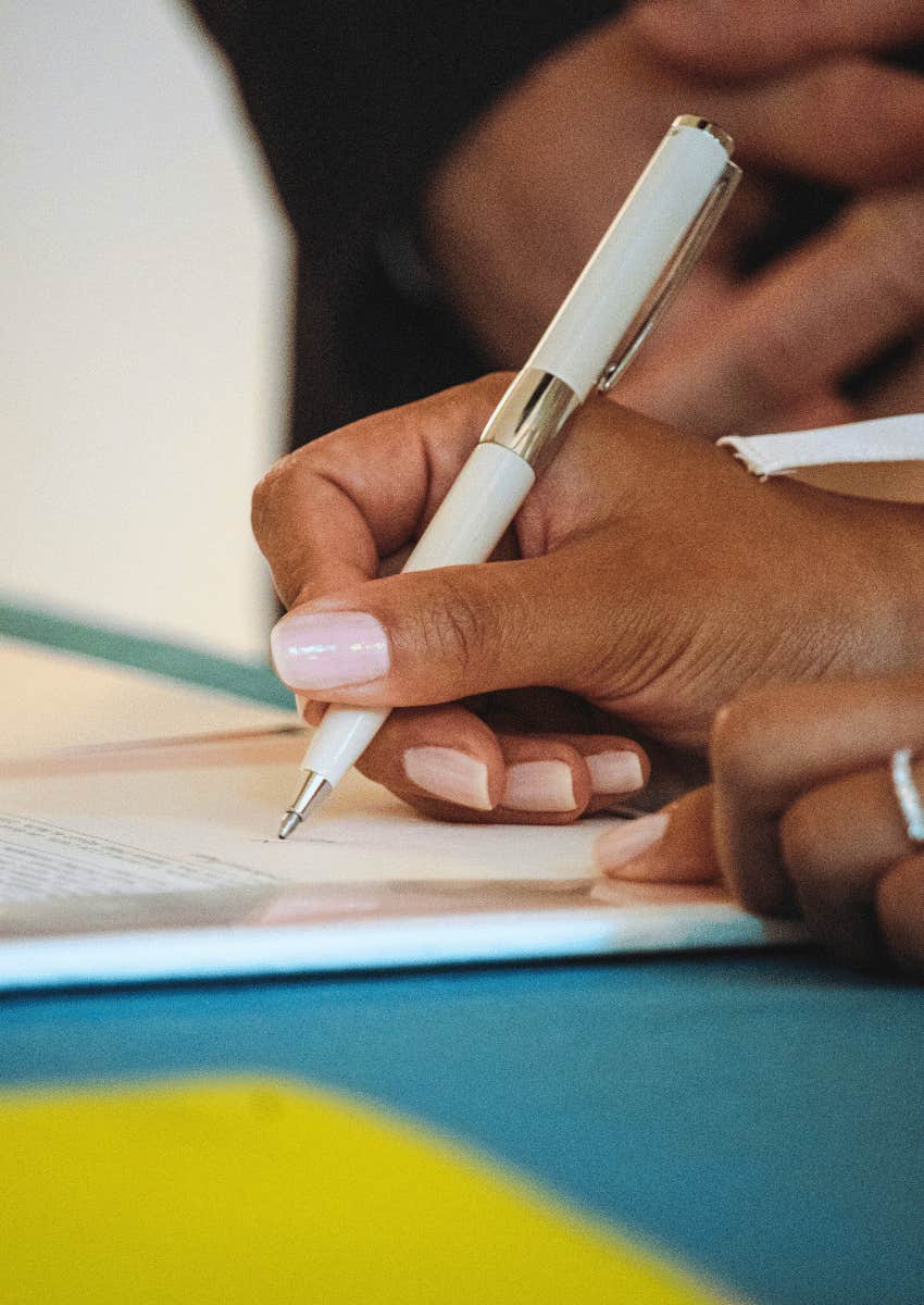 hands signing important documents