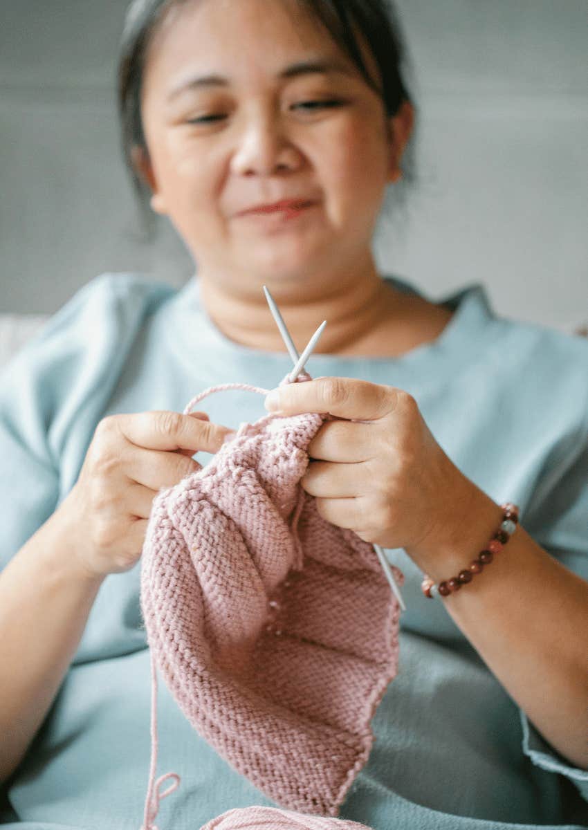 happy midlife woman knitting