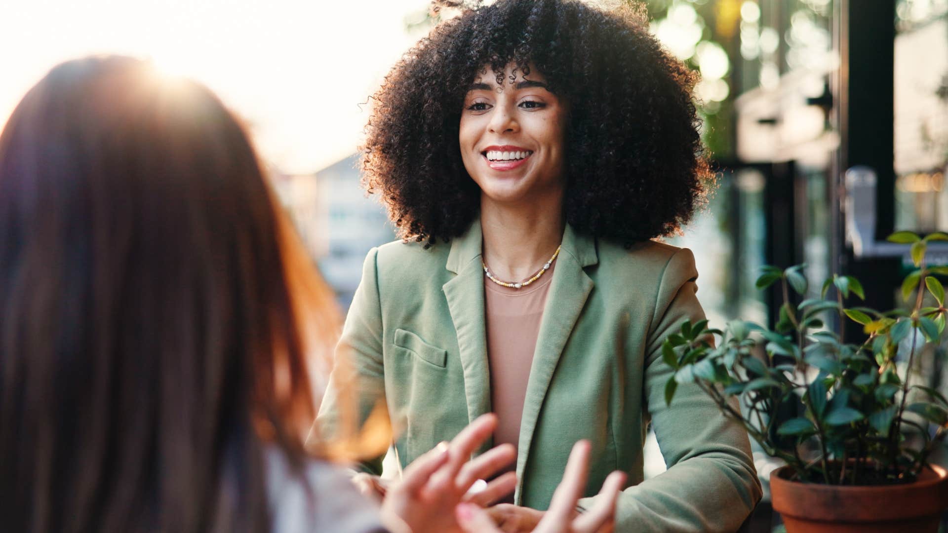 happy woman who's honest without fault talking to a friend