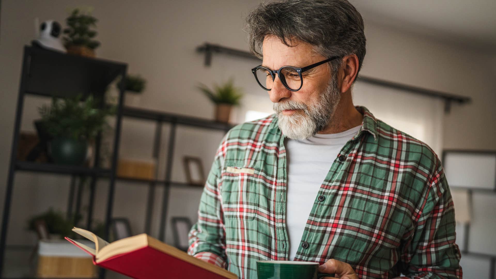 happy man investing in his solitude reading at home