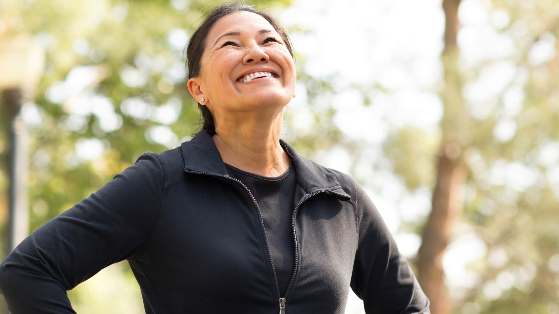 happy woman who leans into healthy routines running outside