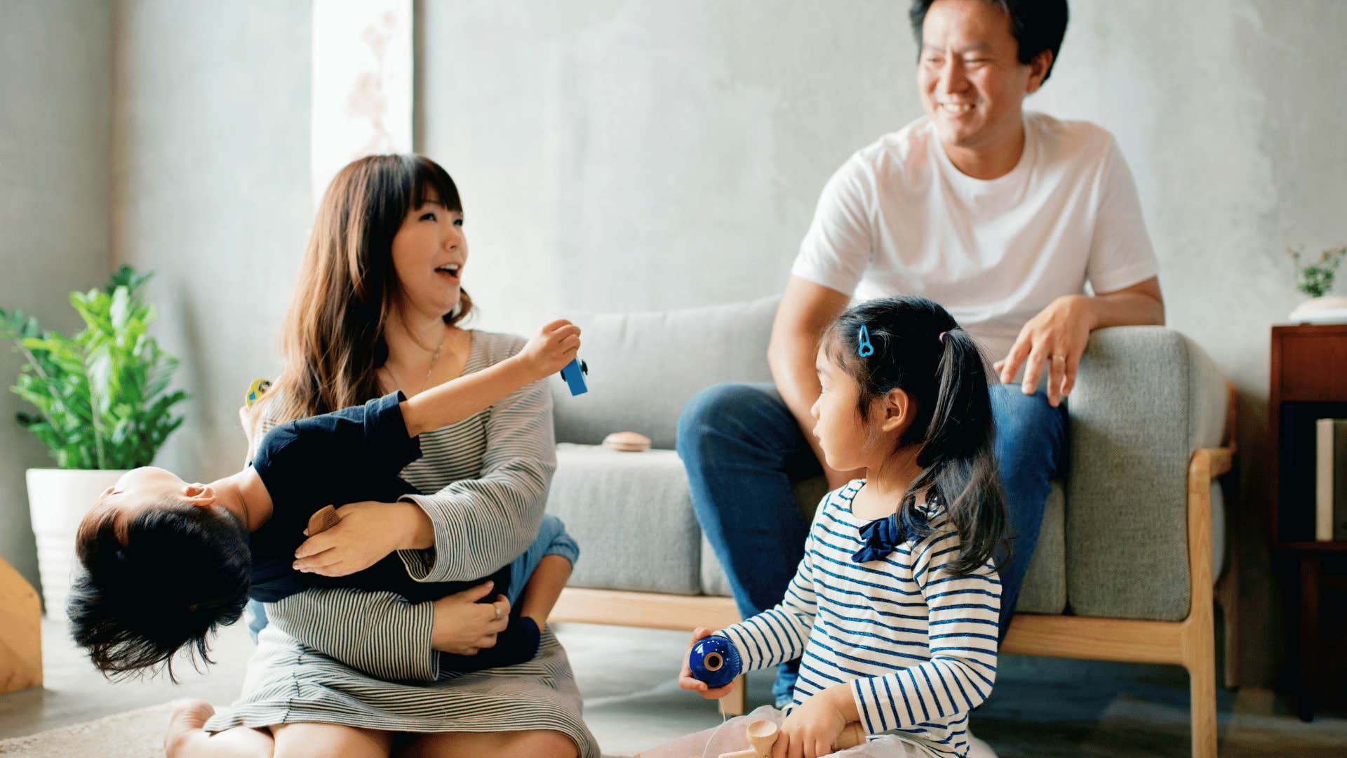 helicopter parents playing with kids on the floor