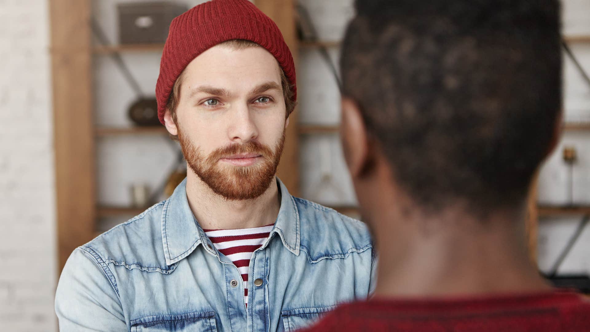 man speaking to condescending friend asking if he's okay