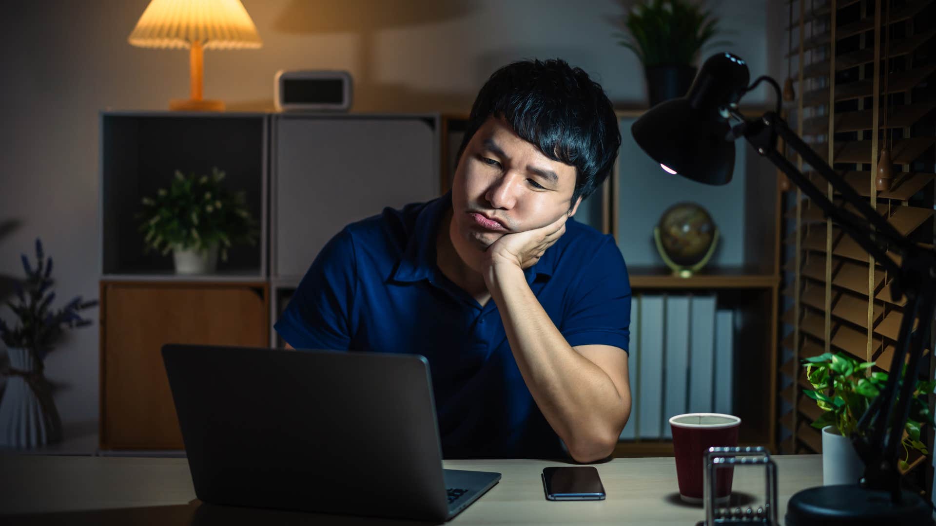 intelligent man working late at night in office