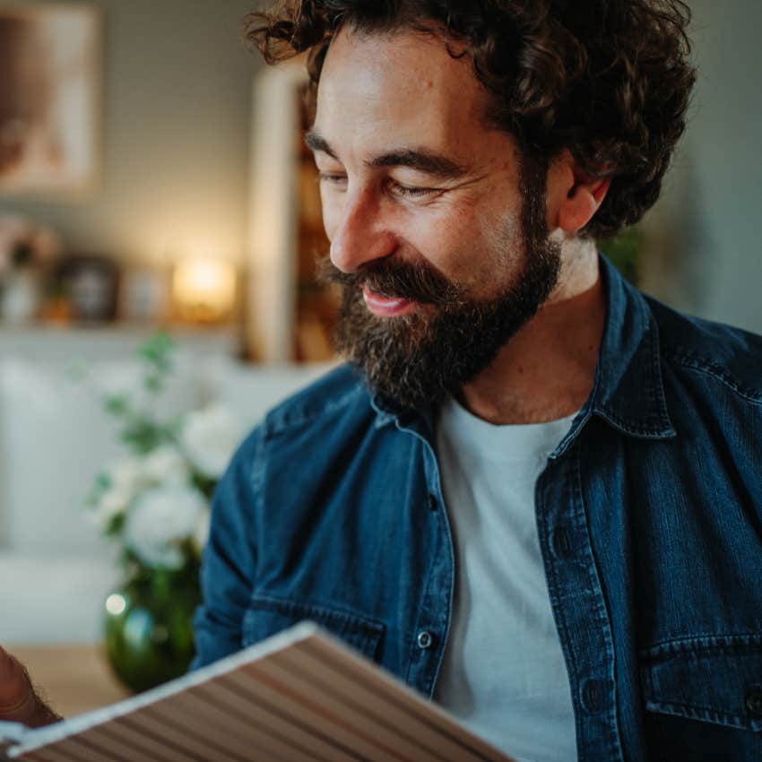 Man who manages their energy journaling at home.