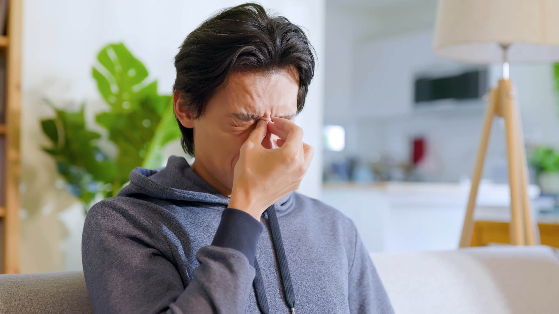 intelligent man rubbing his nose regulating his emotional responses