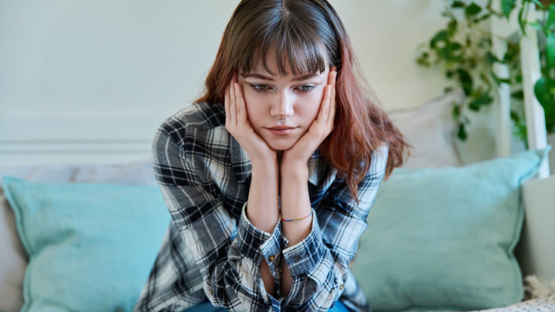 sad woman sitting on couch respecting boundaries of friend who ghosted her