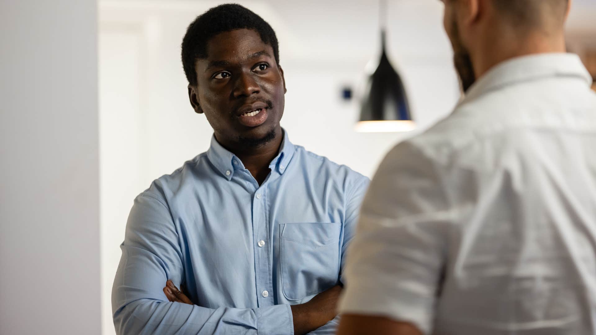 Man saying "I know that isn't the whole story" to a co-worker.