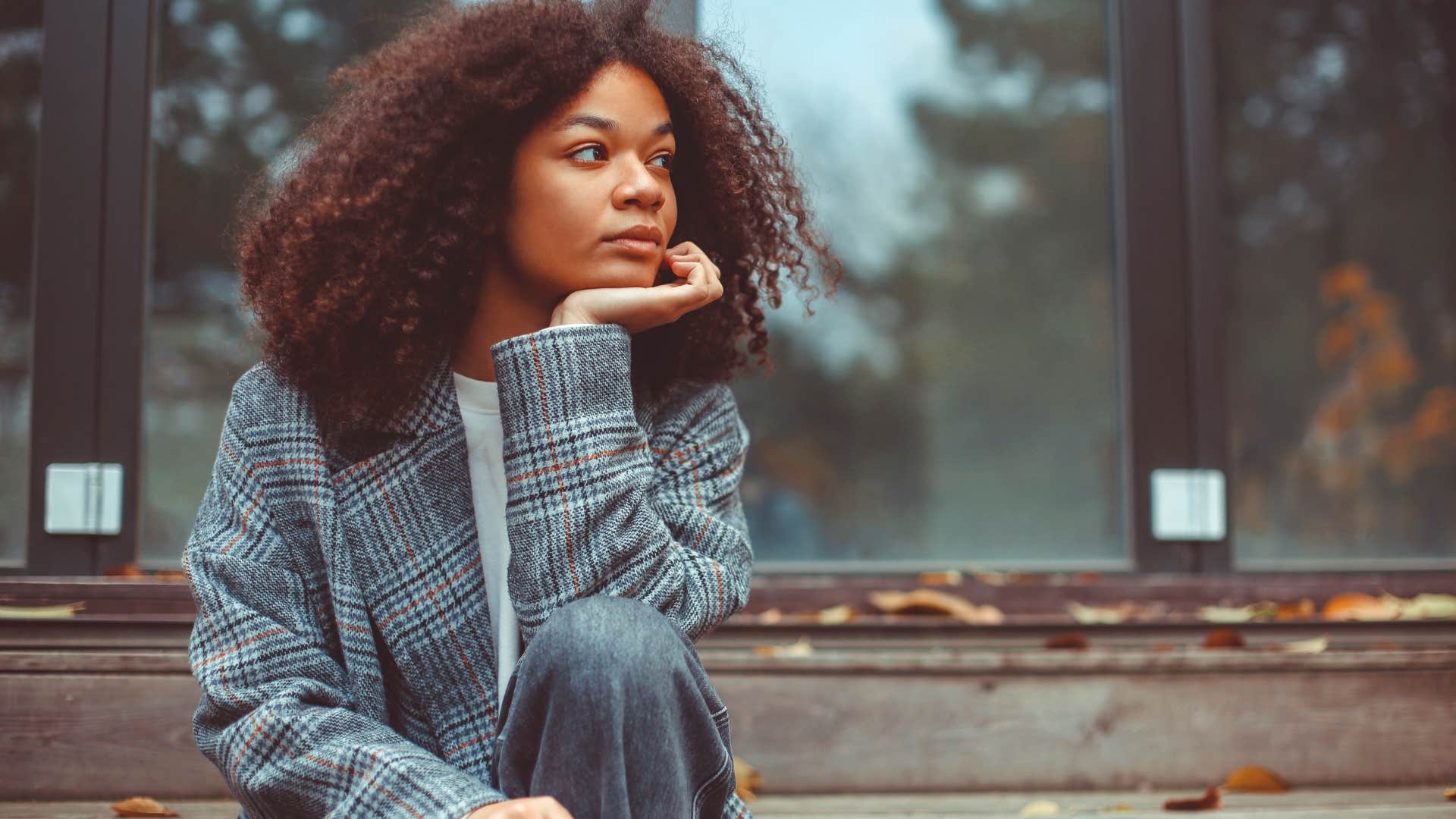 intuitive woman thinking something is about to change sitting outside