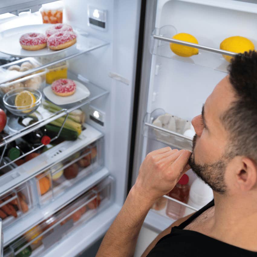 man who has a fully stocked fridge in his home