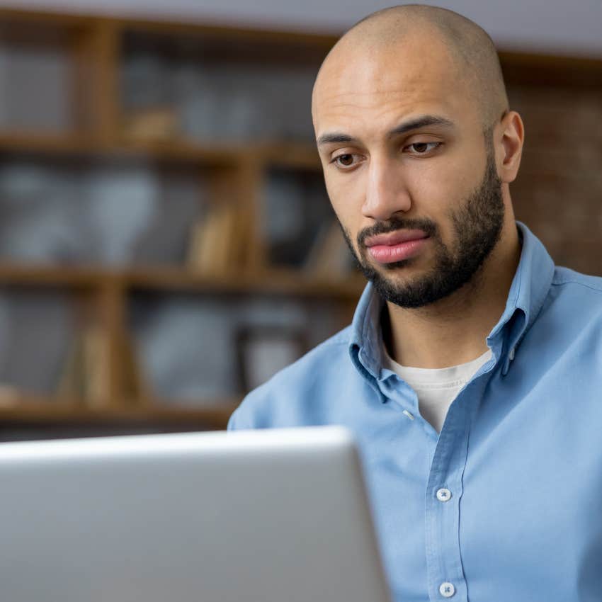 stressed man using chatgpt while working on laptop
