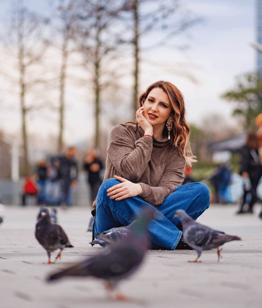 patient woman sitting with pigeons