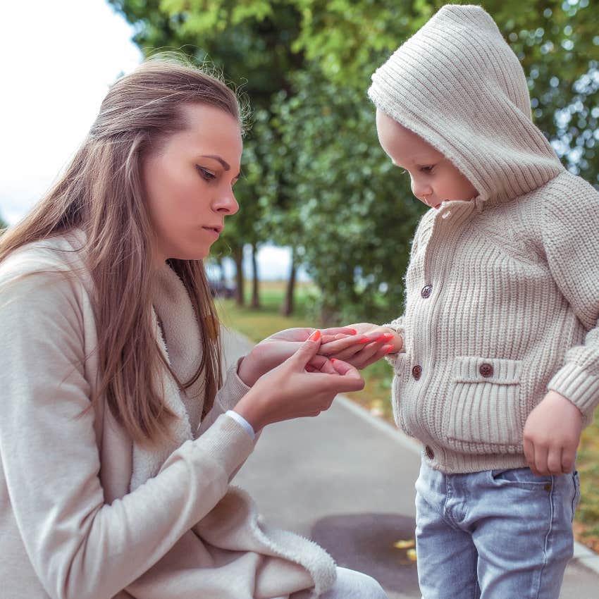 responsible woman holding a bug in her child's hands