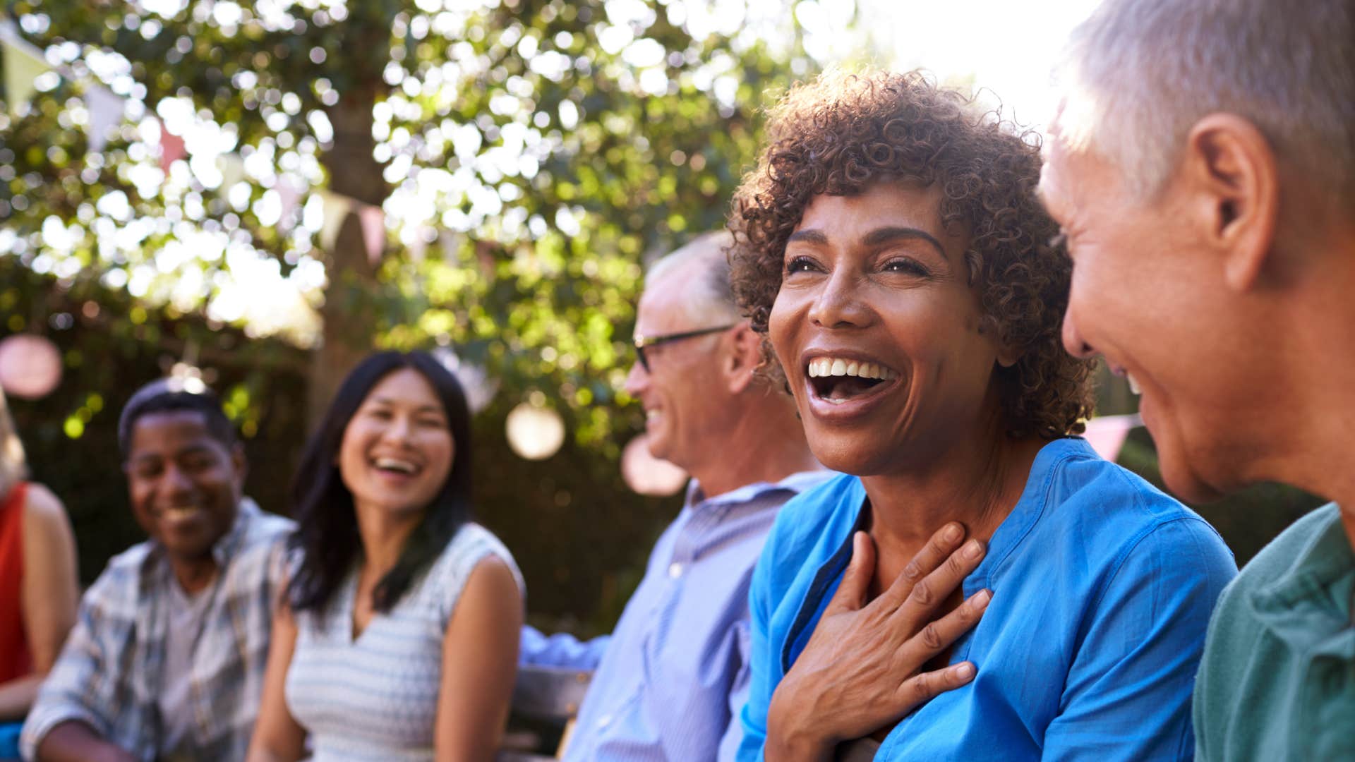 Mom who has a close bond with her kids surrounded by friends 