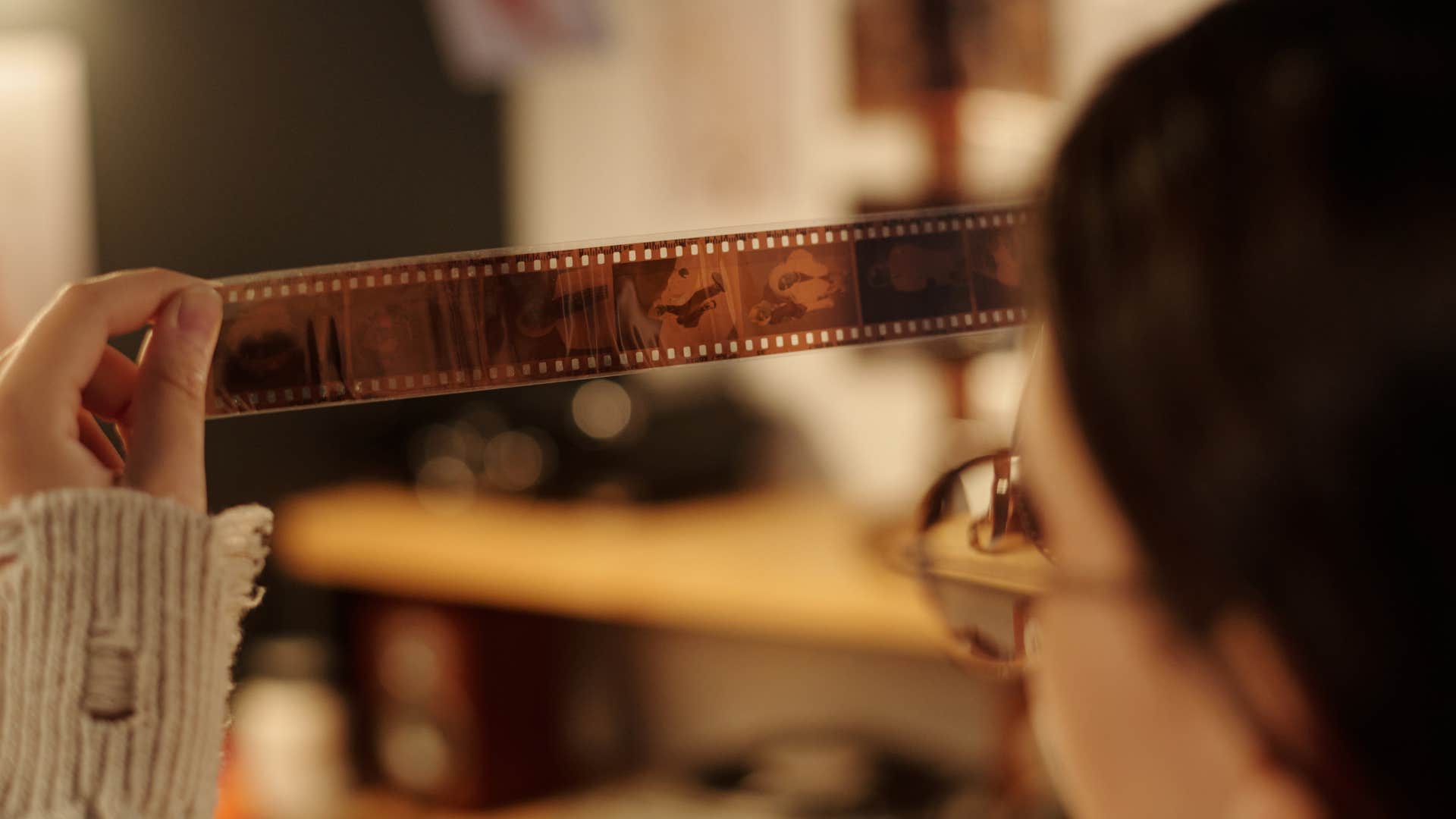 woman developing film holding negatives