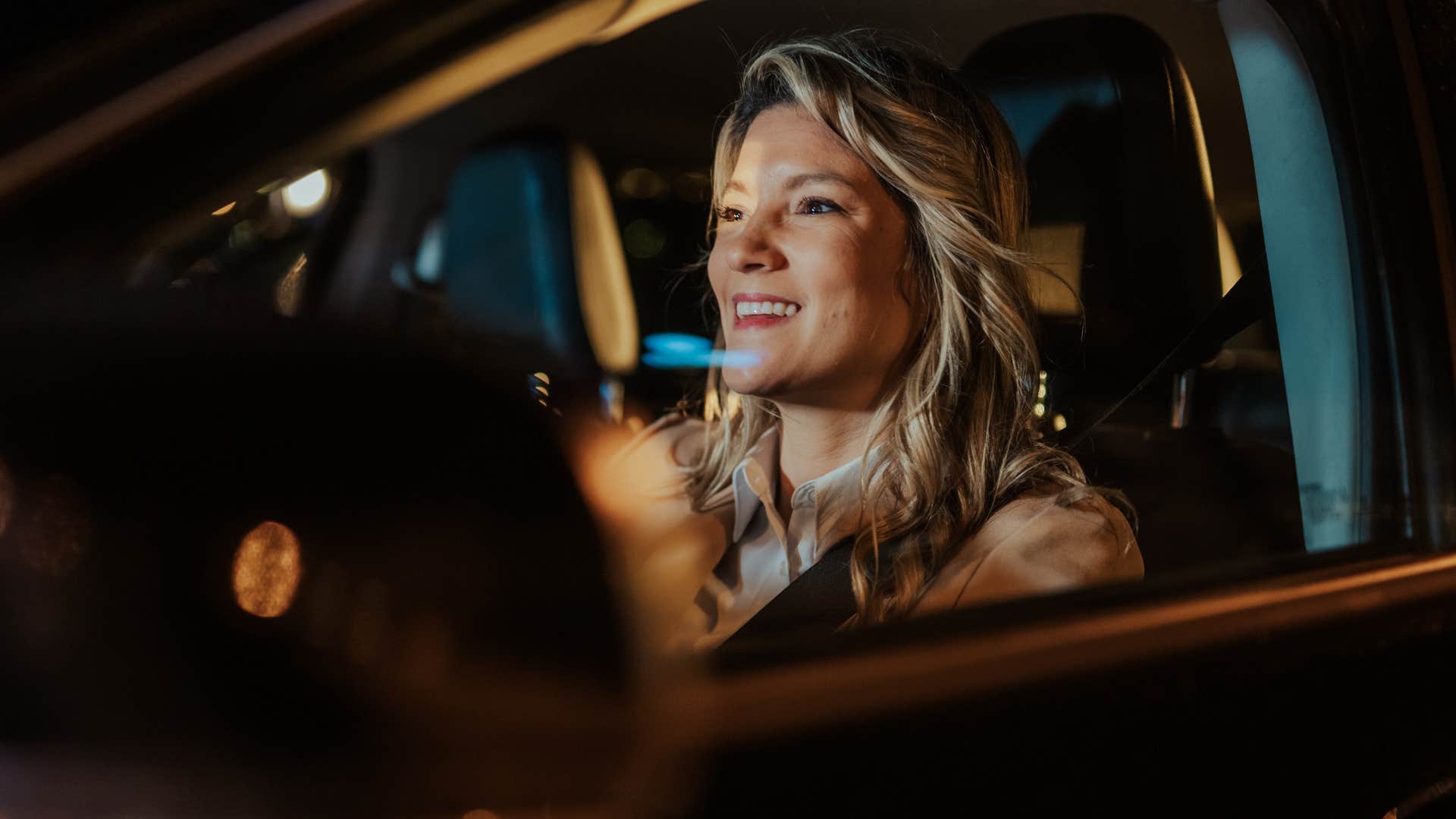 happy woman taking a long drive with no destination