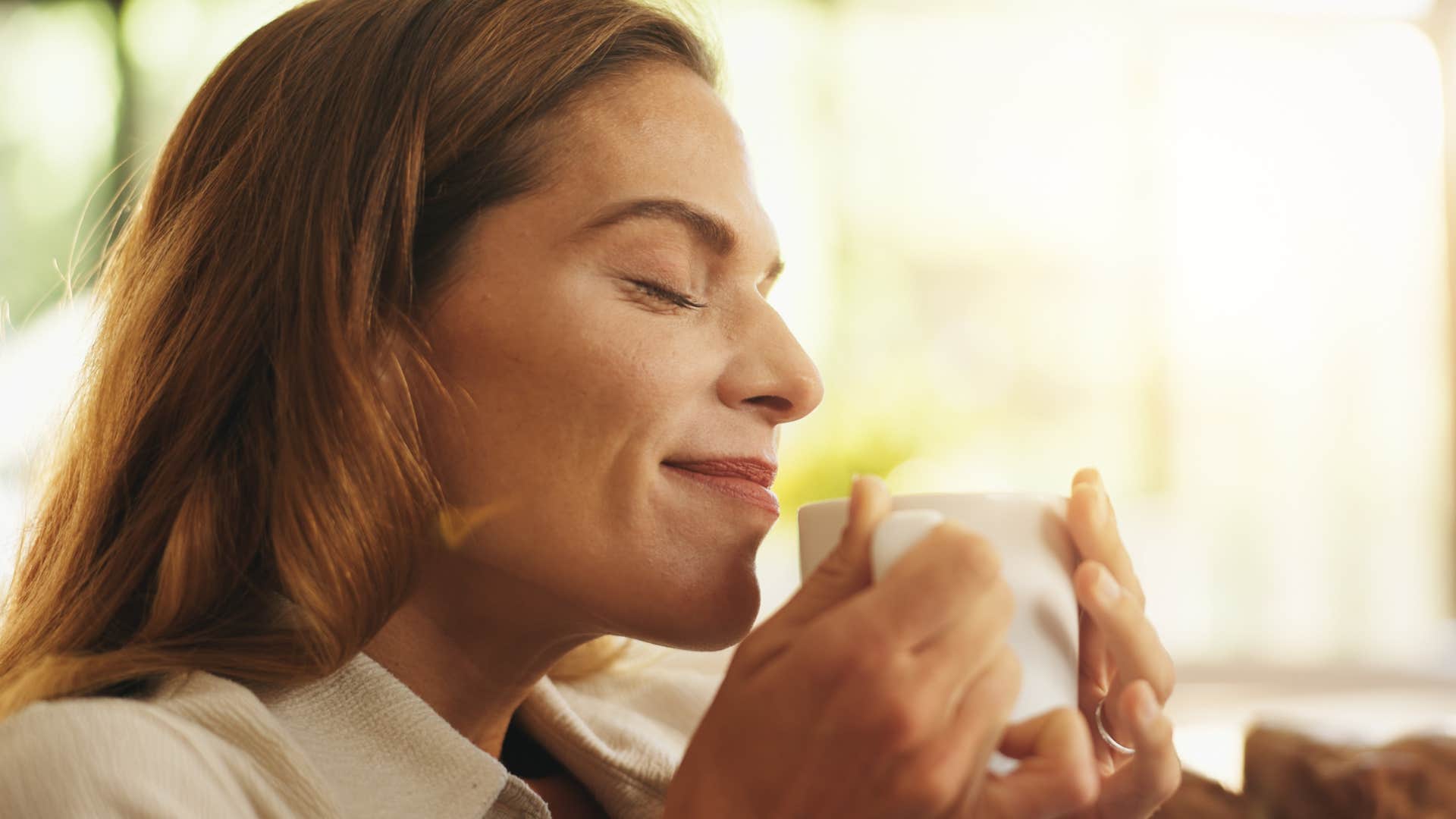 woman feeling peaceful after putting her phone on do not disturb