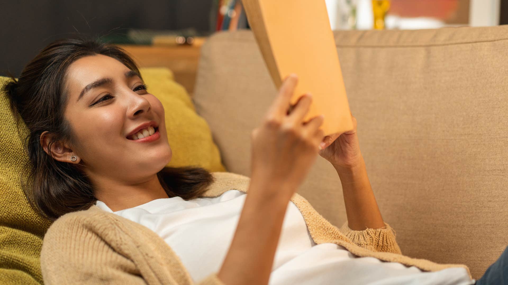 introverted woman delighted to stay in on the weekend reading