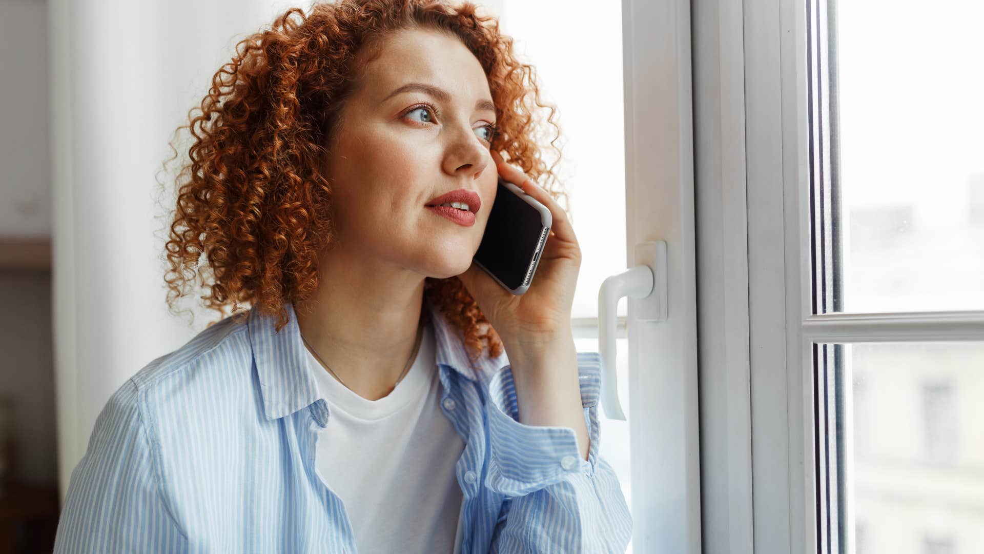 Woman having your struggles invalidated on the phone.